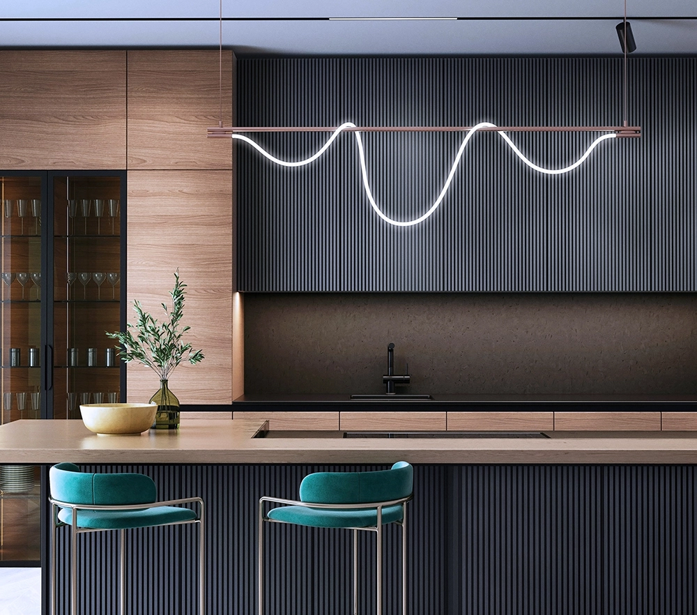 Modern kitchen with wooden cabinets and a sleek light fixture.