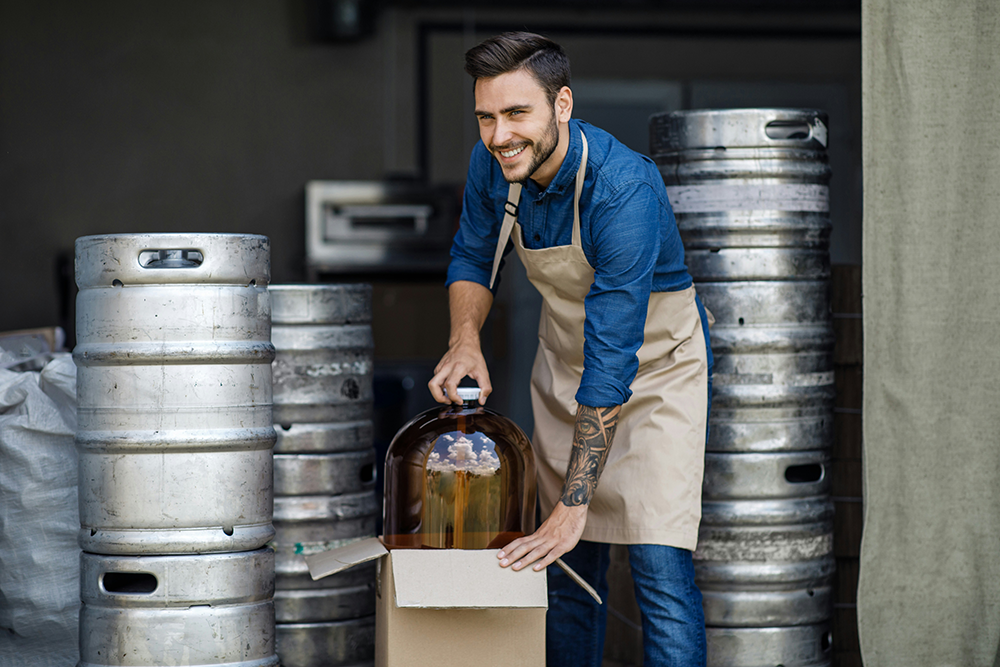 Bar man moving beer kegs