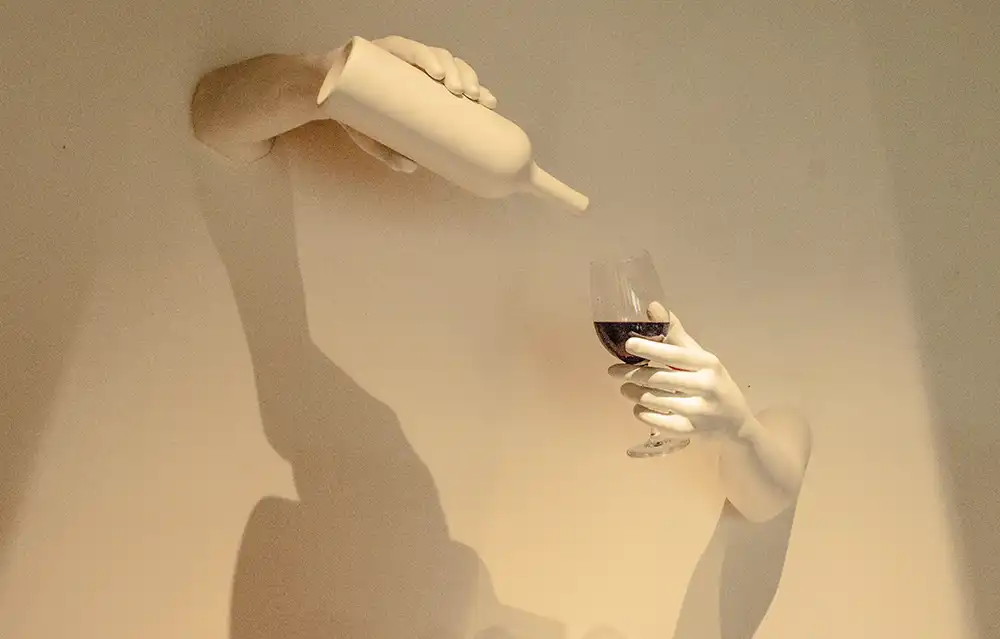 Sculpture of arms holding organic wine.