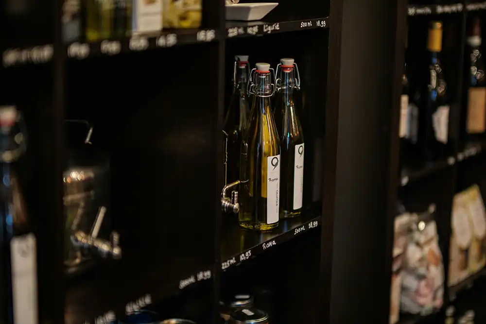 Olive oil Bottles in a deli style shelf
