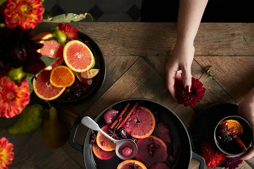 Mulled wine in a pot on table with spices